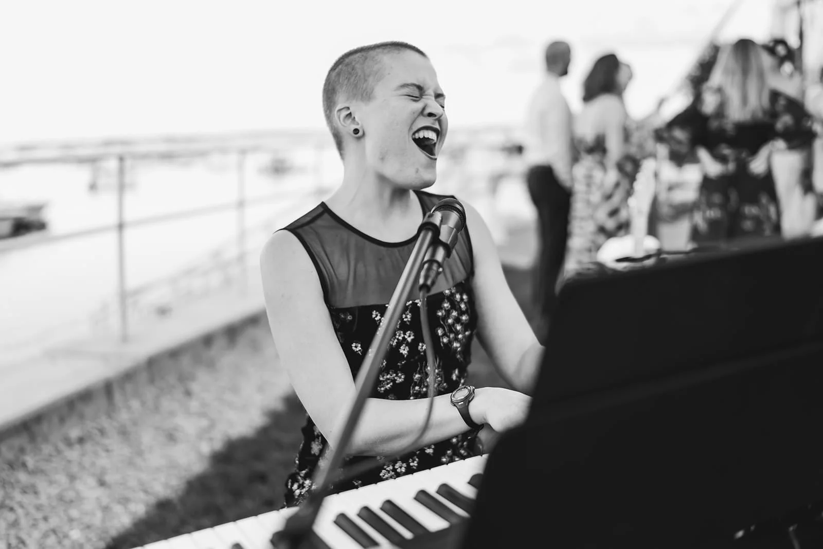 Vanessa Hale singing passionately while playingthe piano