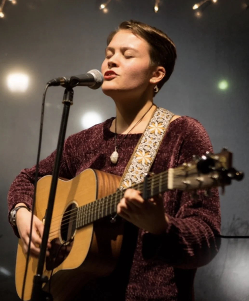 Vanessa Hale singing and playing guitar
